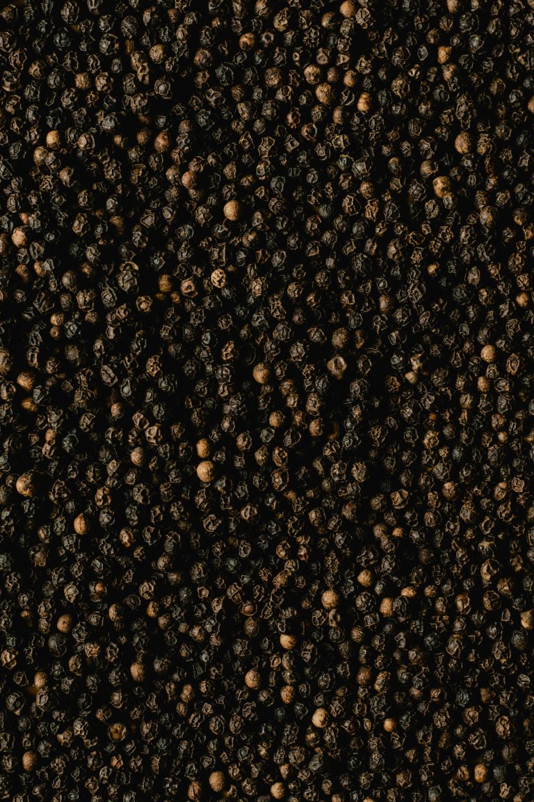Detailed close-up of black peppercorns showcasing texture and spice quality.